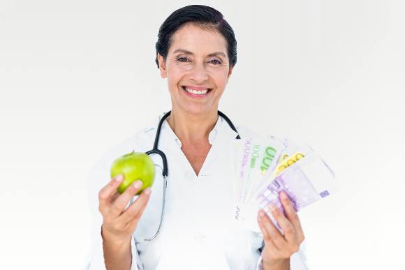Smiling Doctor Holding Apple and Money