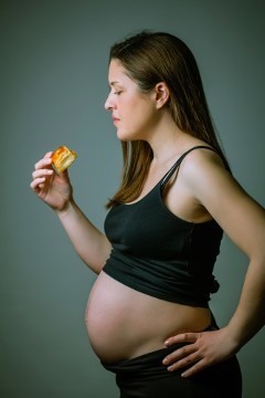 Pregnant Woman Looking at Cake