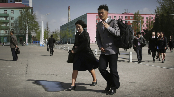 North Koreans walk in downtown Pyongyang on April 18.
