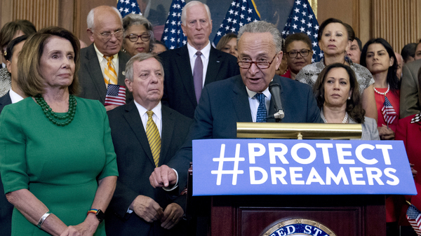 House Minority Leader Nancy Pelosi (left) and other congressional Democrats listen to Senate Minority Leader Chuck Schumer at a Capitol Hill news conference last week.