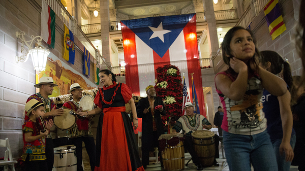 A musical group playing traditional Puerto Rican bomba music performs at a parranda in Hartford, Conn.