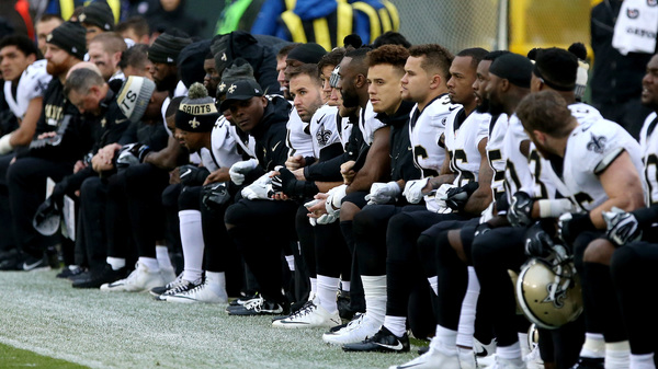 The New Orleans Saints kneel before the playing of the national anthem before the game against the Green Bay Packers at Lambeau Field on Oct. 22.