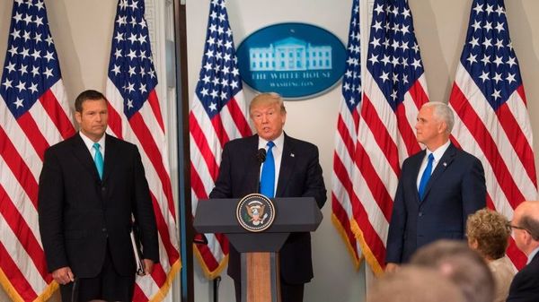 President Trump, flanked by Kansas Secretary of State Kris Kobach and Vice President Pence, speaks during the first meeting of his Presidential Advisory Commission on Election Integrity in July.