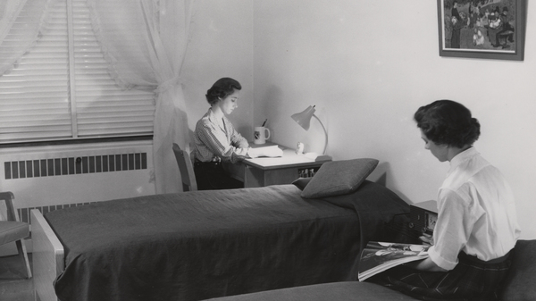 Two roommates in the 1950s study in their shared Duke University dormitory.