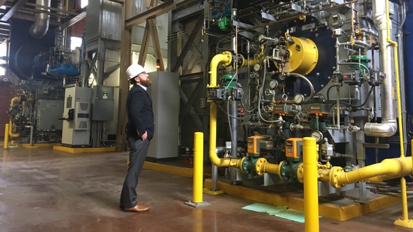 Casey Collins, Duke University energy manager, inspects a boiler at the West Campus Steam Plant. Soon, these boilers will run on swine biogas instead of natural gas.