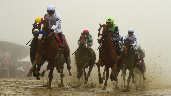 Justify, ridden by Mike Smith, wins the 143rd Preakness Stakes in the mud and fog Saturday to capture the second leg of the Triple Crown in Baltimore.
