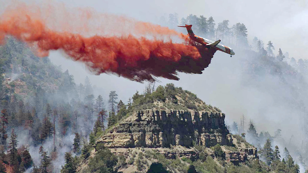 An airplane drops fire retardant on a fire outside of Durango, Colo. The 416 fire has forced 2,500 home evacuations.