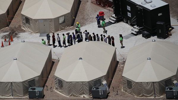 Children and workers are seen at a tent encampment on June 19, 2018 in Tornillo, Texas. The Trump administration is using the tent facility to house immigrant children separated from their parents.