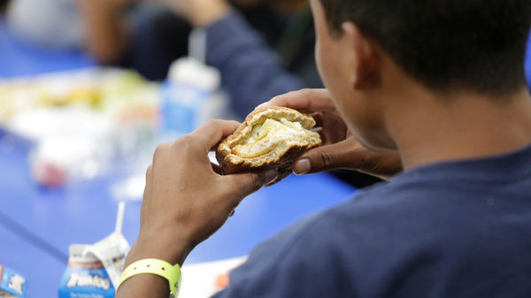 A child eats at an unaccompanied alien children program shelter in Brownsville, Texas, in an undated handout photo that was obtained from the Department of Health and Human Services by Reuters. The government says it separated nearly 2,000 children from adults at the U.S. southern border over the course of six recent weeks.